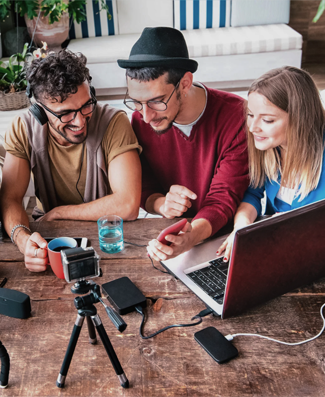 Desilo agency and creator managers collaborating with digital creators on campaigns, using laptop and camera for content production