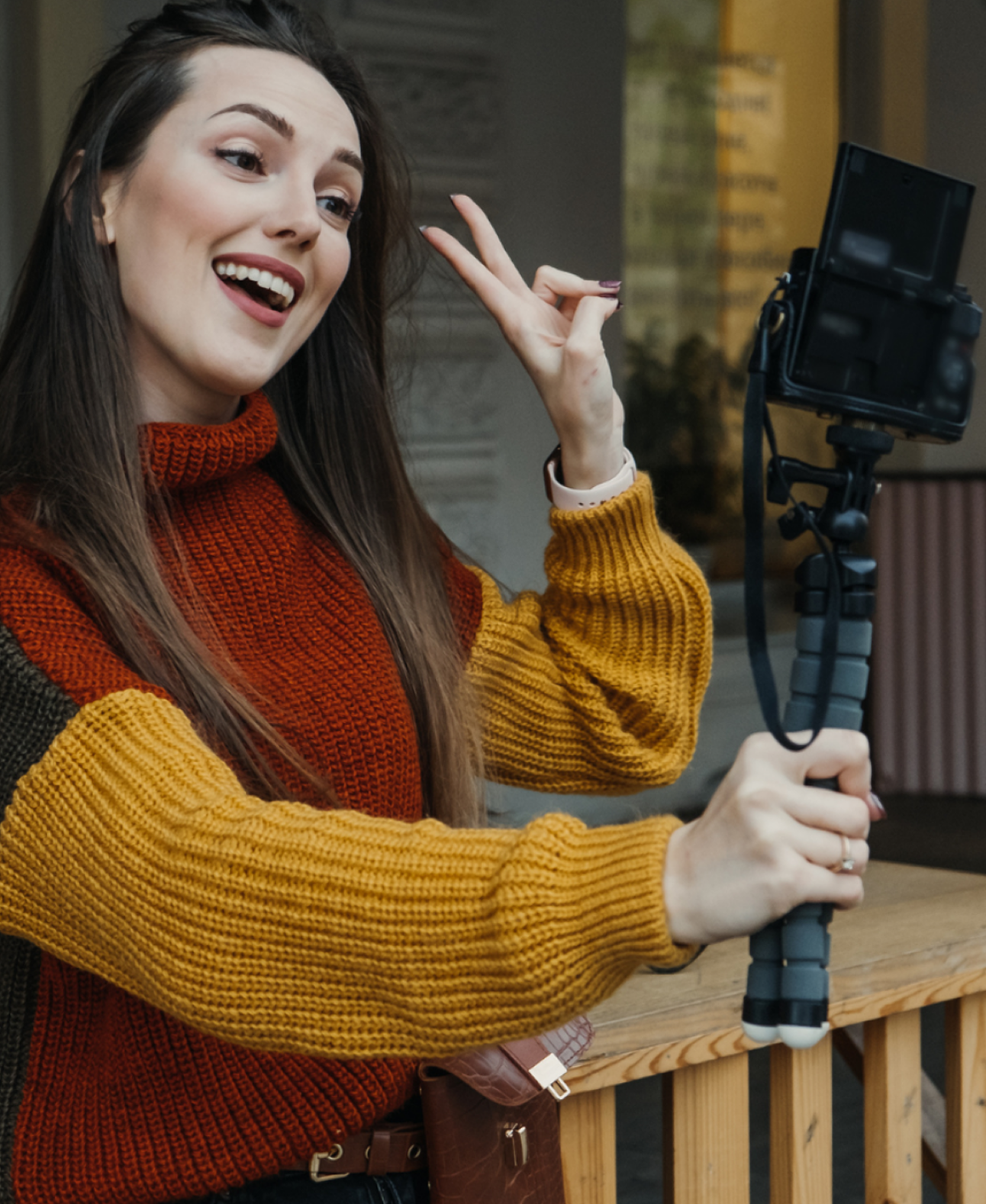 Desilo creator recording content with a handheld camera, vlogging and engaging audience with expressive gestures for social media